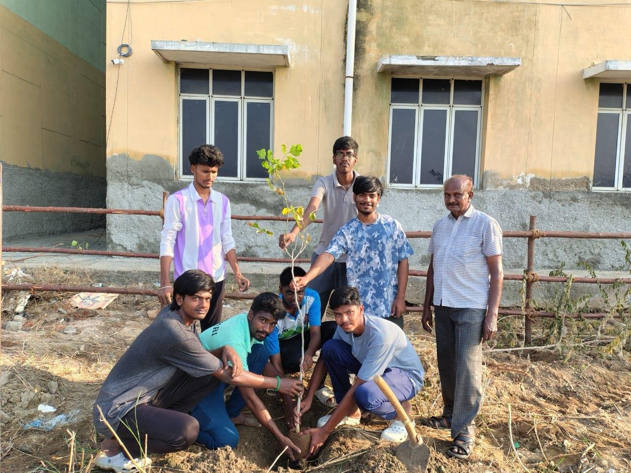 Youth volunteers planting a sapling