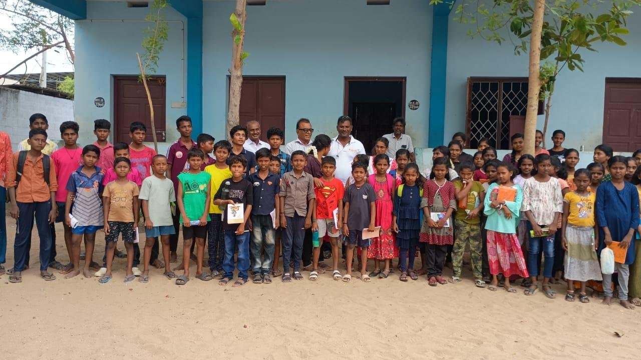 Children with notebooks outside centre