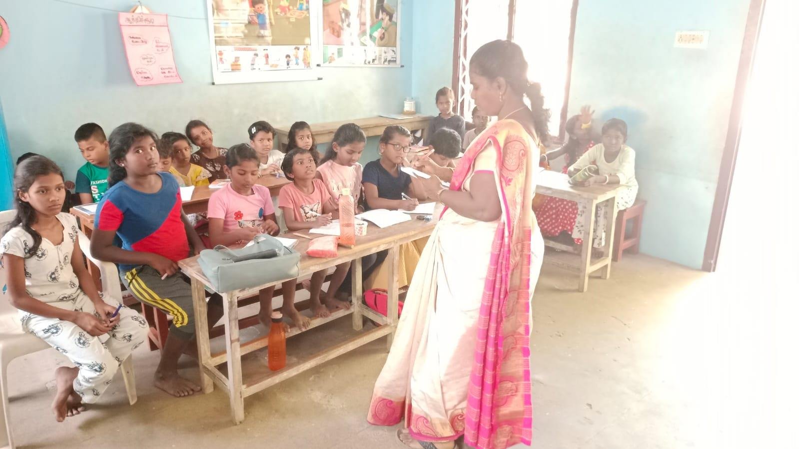 Teacher guiding children in classroom