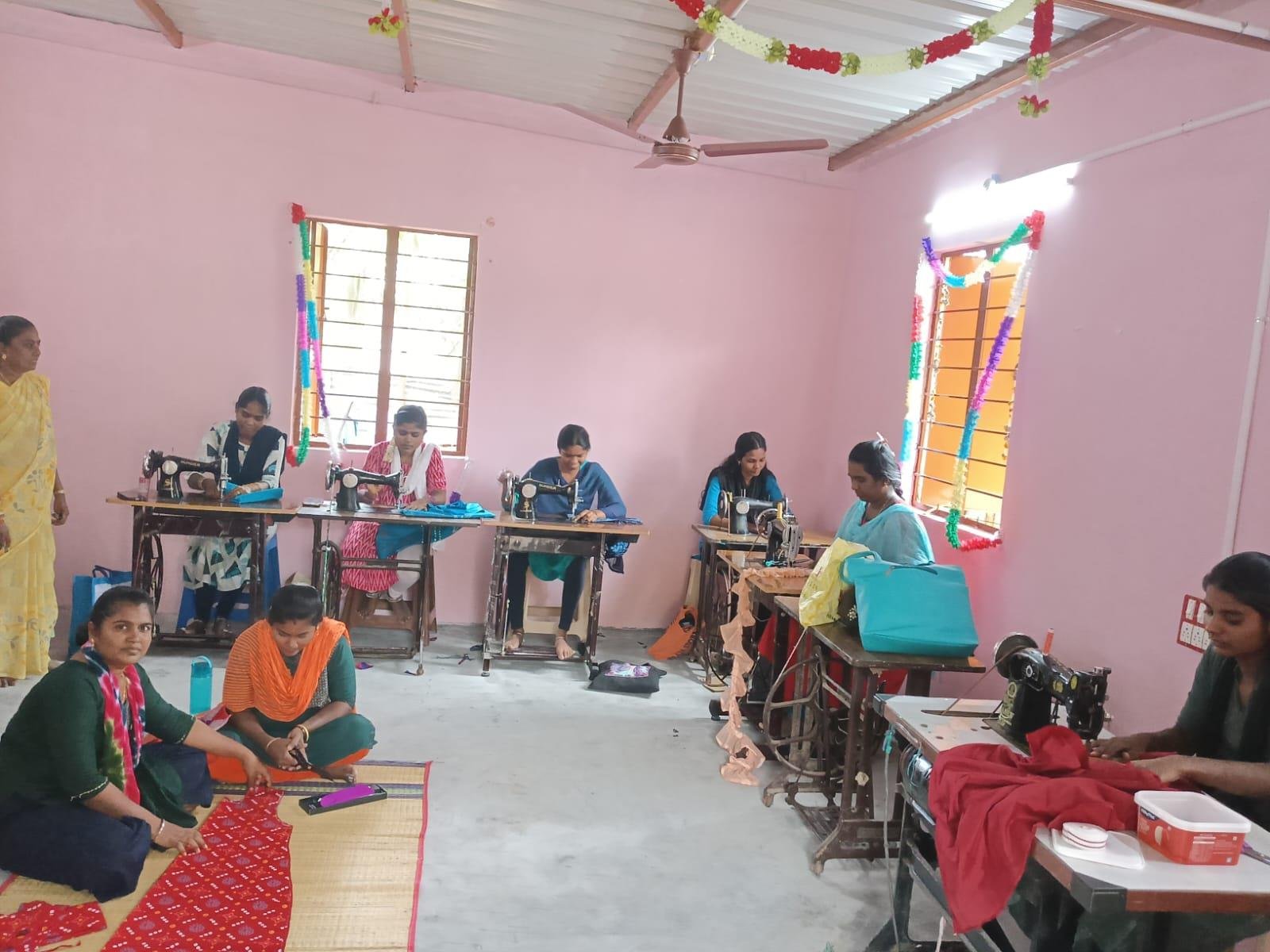 Women learning tailoring on sewing machines