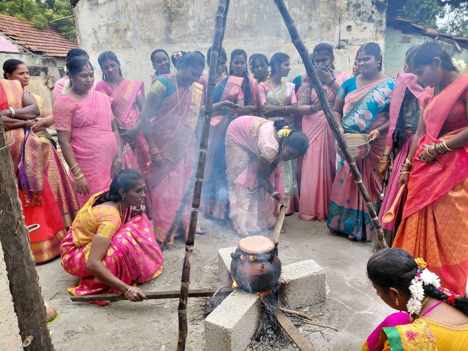Women cooking Pongal over open fire