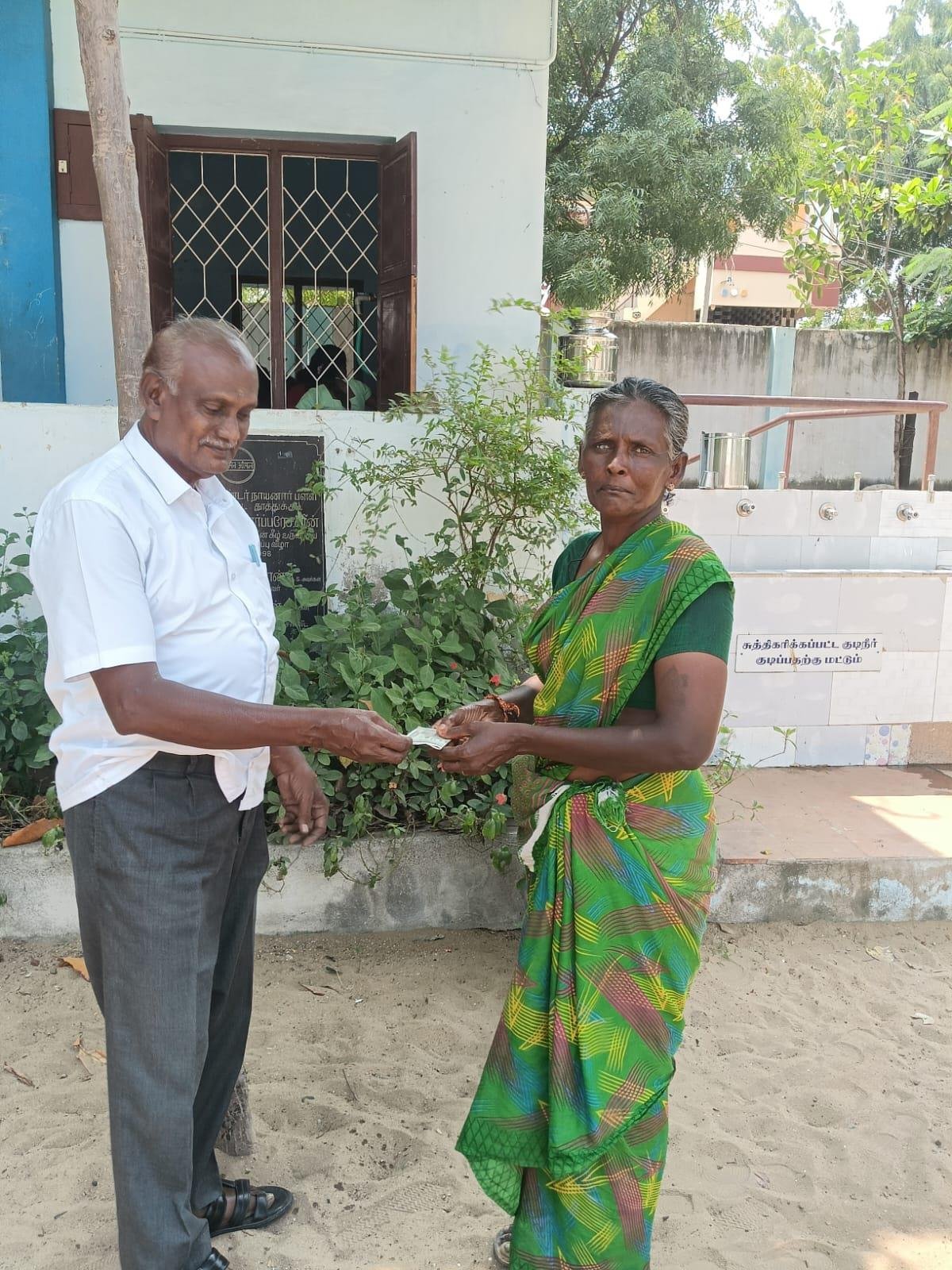 Cash assistance handed to elderly woman